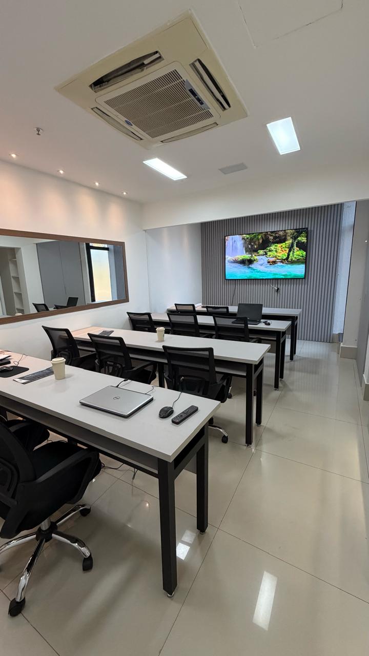 Sala JK em formato de treinamento com a TV ligada
